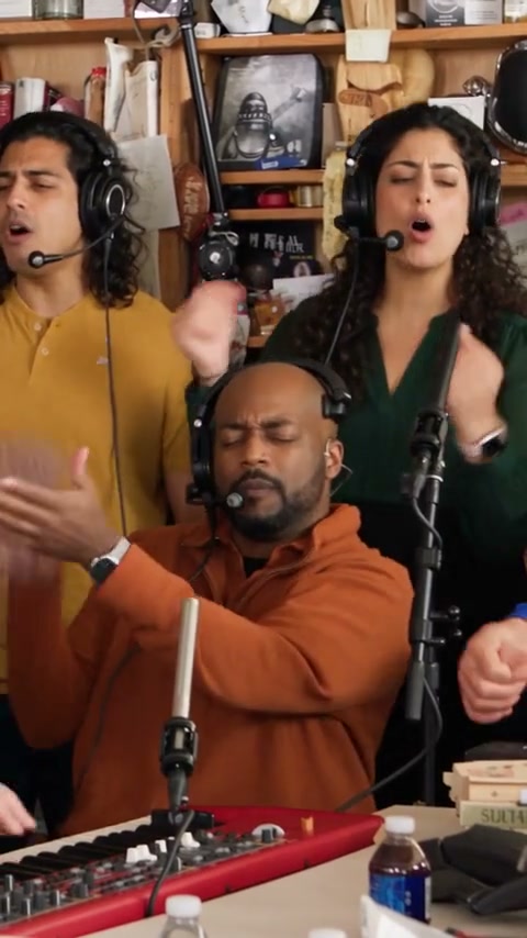 The Tiny Desk AI band shot: a keyboard player and two backup singers